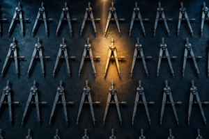 A grid of identical steel precision instruments laid out in dim shadow, with one instrument near the center lifted and lit by warm golden light, representing the difference between commodity tools and the scarce judgment to use them well.